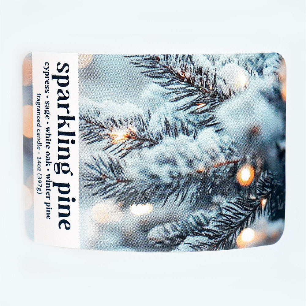 Candle packaging with 'sparkling pine' text and a snowy pine branch design.