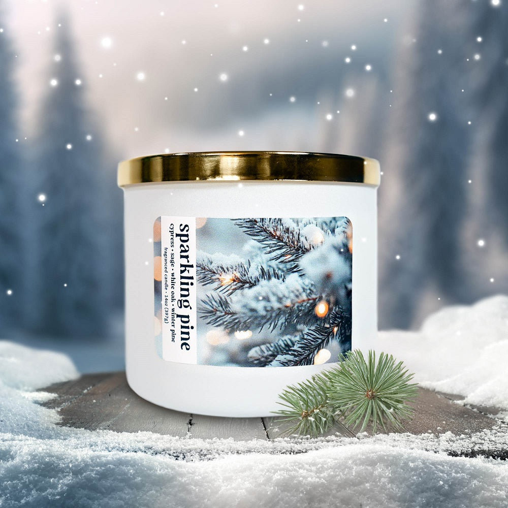 Candle with a 'Sparkling Pine' label in a snowy forest setting
