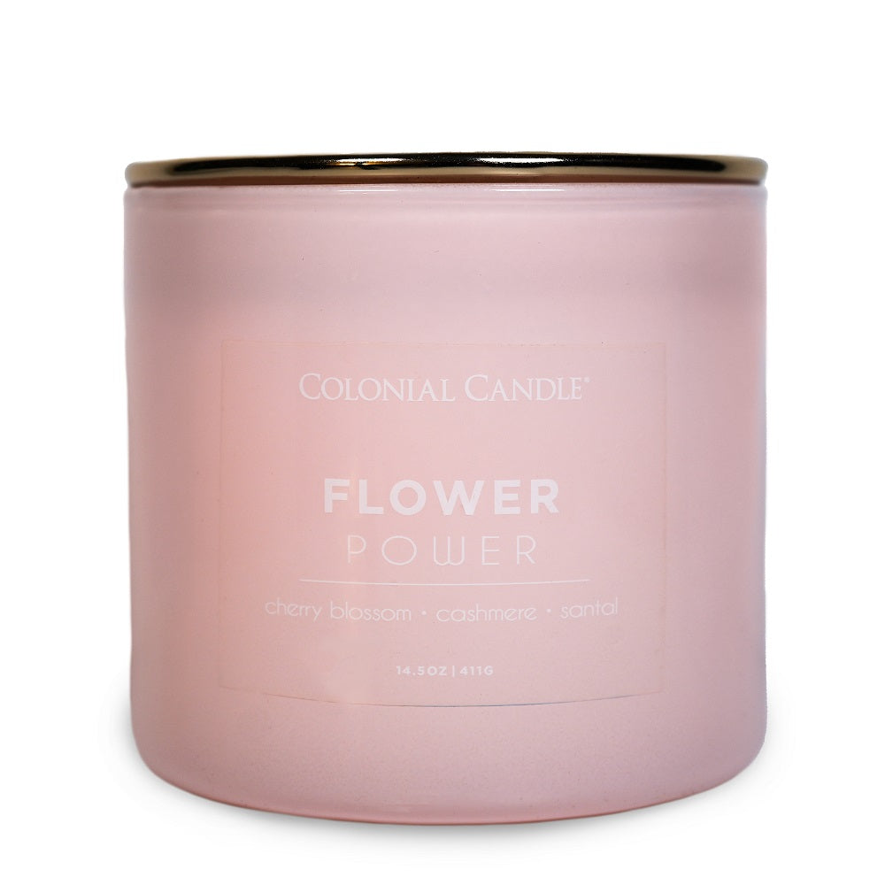 Pink candle with 'Colonial Candle Flower Power' text on a white background