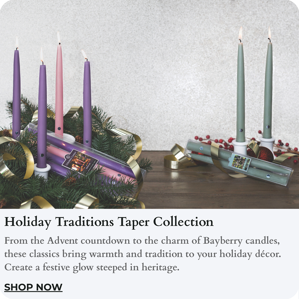 Two advent candle sets with candles lit on a wooden surface, featuring text about the 'Holiday Traditions Taper Collection'.