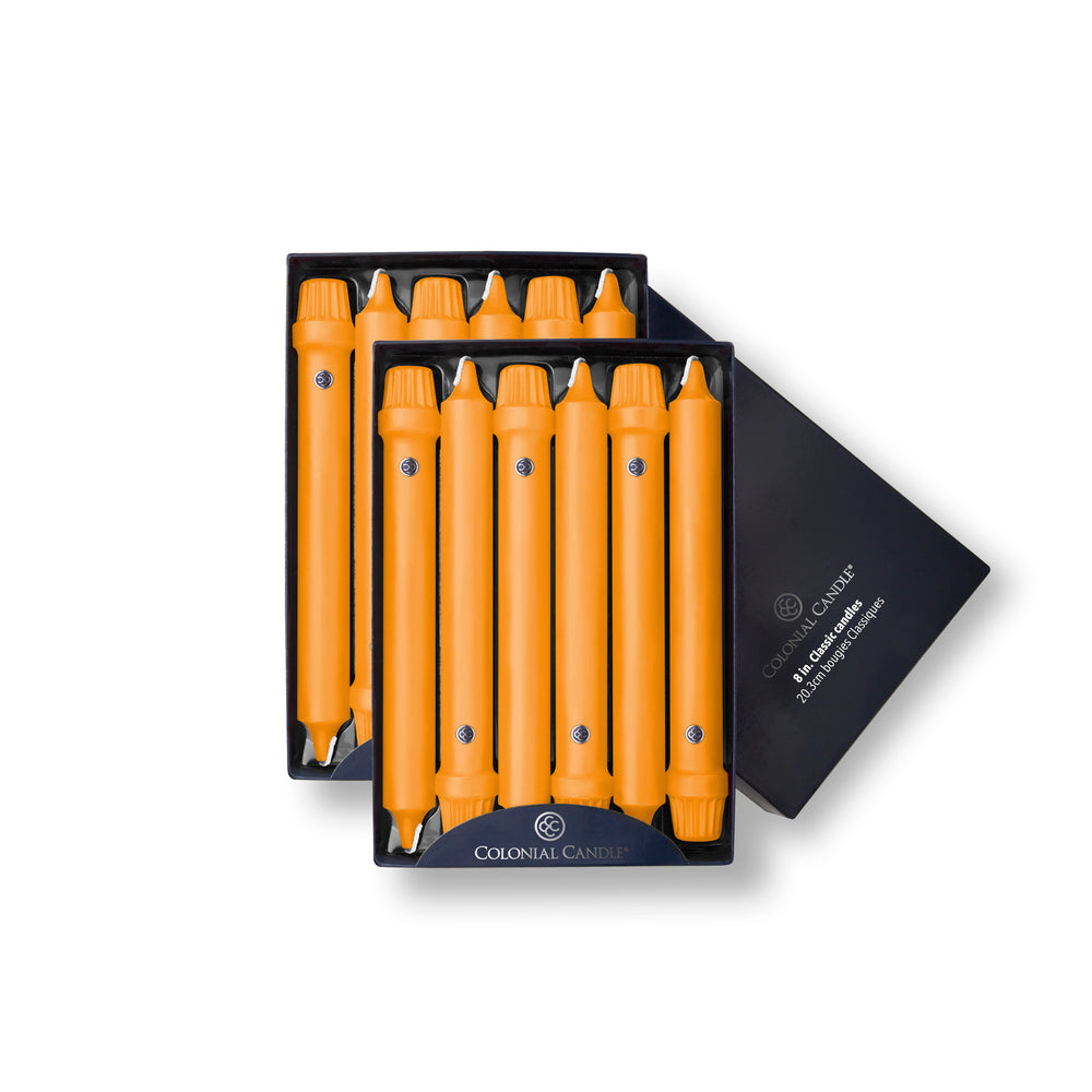 A pack of twelve caramel-colored Colonial Classic taper candles presented in a black box with a beveled base design.