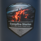 Label of 'Campfire Stories' candle featuring a campfire design on a blue background