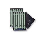A pack of eight Colonial Green Classic taper candles presented in a black box with the Colonial Candle brand visible.